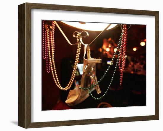 A Woman's High Heeled Shoe Hangs with Some Mardi Gras Beads-null-Framed Premium Photographic Print