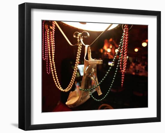 A Woman's High Heeled Shoe Hangs with Some Mardi Gras Beads-null-Framed Premium Photographic Print