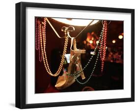 A Woman's High Heeled Shoe Hangs with Some Mardi Gras Beads-null-Framed Premium Photographic Print