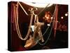 A Woman's High Heeled Shoe Hangs with Some Mardi Gras Beads-null-Stretched Canvas