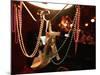 A Woman's High Heeled Shoe Hangs with Some Mardi Gras Beads-null-Mounted Photographic Print