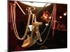 A Woman's High Heeled Shoe Hangs with Some Mardi Gras Beads-null-Mounted Photographic Print