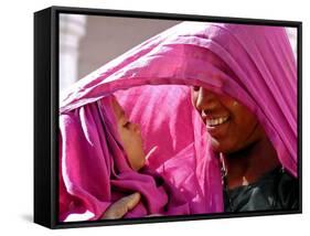 A Woman Shields Her Child from the Sun Using Her Scarf-null-Framed Stretched Canvas