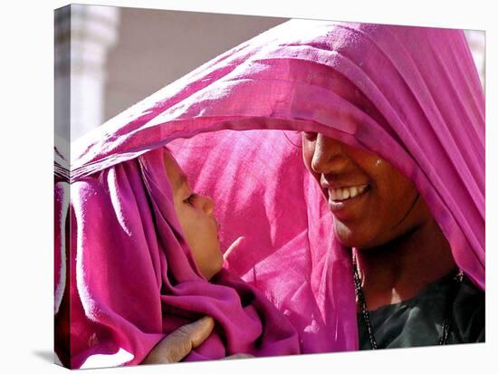 A Woman Shields Her Child from the Sun Using Her Scarf-null-Stretched Canvas