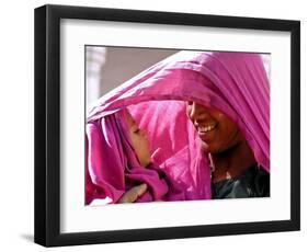 A Woman Shields Her Child from the Sun Using Her Scarf-null-Framed Photographic Print