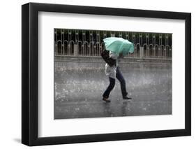 A Woman Struggles to Hold an Umbrella as She Walks Through a Storm in Beijing-David Gray-Framed Photographic Print