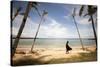 A Woman Walks with Her Shoes Off on the Beach Near the Exclusive Balesin Island Club, Philippines-Carlo Acenas-Stretched Canvas