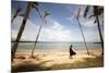 A Woman Walks with Her Shoes Off on the Beach Near the Exclusive Balesin Island Club, Philippines-Carlo Acenas-Mounted Photographic Print