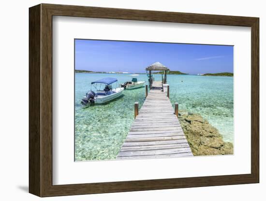 A Wood Pier Leads to Moored Boats and Clear Tropical Waters Near Staniel Cay, Exuma, Bahamas-James White-Framed Photographic Print