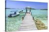 A Wood Pier Leads to Moored Boats and Clear Tropical Waters Near Staniel Cay, Exuma, Bahamas-James White-Stretched Canvas