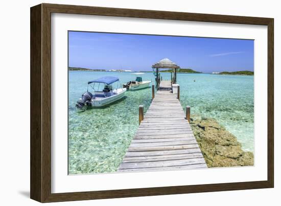 A Wood Pier Leads to Moored Boats and Clear Tropical Waters Near Staniel Cay, Exuma, Bahamas-James White-Framed Photographic Print