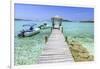 A Wood Pier Leads to Moored Boats and Clear Tropical Waters Near Staniel Cay, Exuma, Bahamas-James White-Framed Photographic Print