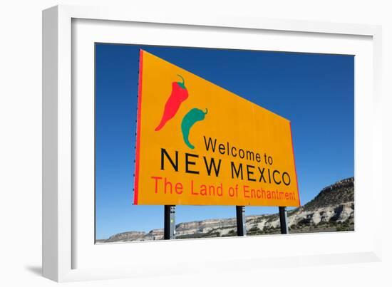 A Yellow Welcome to New Mexico Sign in Front of a Blue Sky-flippo-Framed Photographic Print