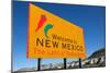 A Yellow Welcome to New Mexico Sign in Front of a Blue Sky-flippo-Mounted Photographic Print