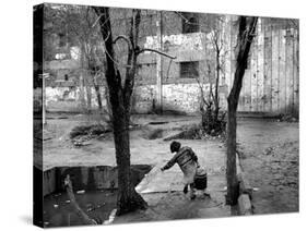 A Young Afghan Girl Carries Water from a Well to Her Family-null-Stretched Canvas