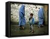 A Young Afghan Refugee Boy Stands in a Pair of Adult's Shoes-null-Framed Stretched Canvas