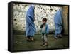 A Young Afghan Refugee Boy Stands in a Pair of Adult's Shoes-null-Framed Stretched Canvas