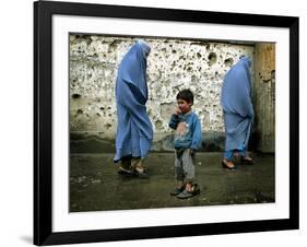 A Young Afghan Refugee Boy Stands in a Pair of Adult's Shoes-null-Framed Photographic Print