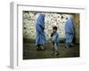 A Young Afghan Refugee Boy Stands in a Pair of Adult's Shoes-null-Framed Photographic Print