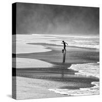 A Young Boy Kicks a Ball on Itamambuca Beach in Ubatuba, Brazil-Alex Saberi-Stretched Canvas