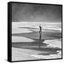 A Young Boy Kicks a Ball on Itamambuca Beach in Ubatuba, Brazil-Alex Saberi-Framed Stretched Canvas