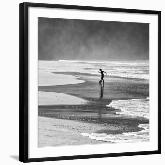 A Young Boy Kicks a Ball on Itamambuca Beach in Ubatuba, Brazil-Alex Saberi-Framed Premium Photographic Print