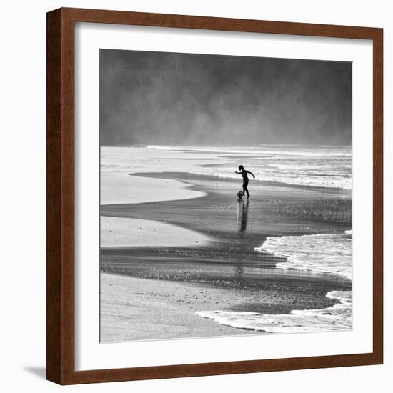 A Young Boy Kicks a Ball on Itamambuca Beach in Ubatuba, Brazil-Alex Saberi-Framed Photographic Print