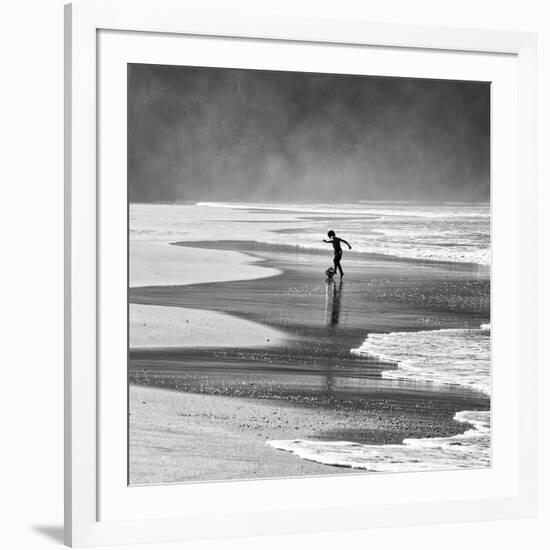 A Young Boy Kicks a Ball on Itamambuca Beach in Ubatuba, Brazil-Alex Saberi-Framed Photographic Print