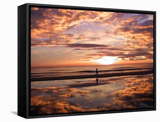 A Young Boy Takes an Early Morning Jog as the Sun Rises Along China Beach-null-Framed Stretched Canvas