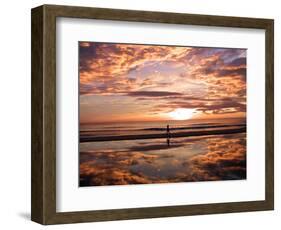 A Young Boy Takes an Early Morning Jog as the Sun Rises Along China Beach-null-Framed Photographic Print