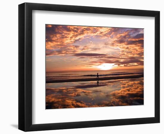 A Young Boy Takes an Early Morning Jog as the Sun Rises Along China Beach-null-Framed Photographic Print