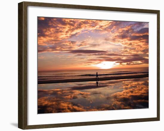 A Young Boy Takes an Early Morning Jog as the Sun Rises Along China Beach-null-Framed Photographic Print