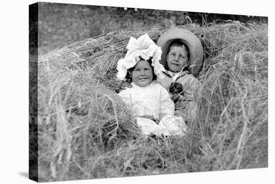 A Young Brother and Sister Nestled in the Hay, Ca. 1900-null-Stretched Canvas