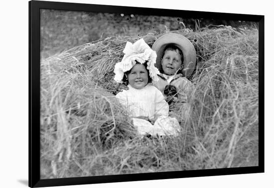 A Young Brother and Sister Nestled in the Hay, Ca. 1900-null-Framed Photographic Print