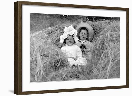 A Young Brother and Sister Nestled in the Hay, Ca. 1900-null-Framed Photographic Print
