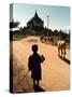A Young Burmese Boy Tends His Family's Cows Near the Thatbinnyu Temple-null-Stretched Canvas