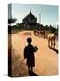 A Young Burmese Boy Tends His Family's Cows Near the Thatbinnyu Temple-null-Stretched Canvas