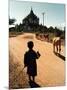 A Young Burmese Boy Tends His Family's Cows Near the Thatbinnyu Temple-null-Mounted Photographic Print