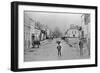 A Young Delivery Boy Stands Nonchalantly in the Main Street of Clonmorris-Thomas Wynne-Framed Giclee Print