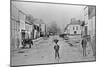 A Young Delivery Boy Stands Nonchalantly in the Main Street of Clonmorris-Thomas Wynne-Mounted Giclee Print