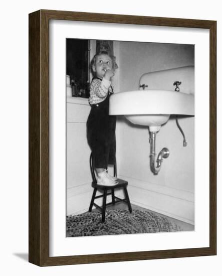 A Young Girl Brushes Her Teeth at the Sink, Ca. 1955-null-Framed Photographic Print