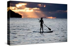 A Young Girl on a Stand Up Paddle Board on Baleia Beach at Sunset-Alex Saberi-Stretched Canvas