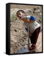 A Young Internally-Displaced Child at a Camp for Displaced Iraqis Who Have Fled Violence-null-Framed Stretched Canvas