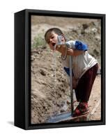 A Young Internally-Displaced Child at a Camp for Displaced Iraqis Who Have Fled Violence-null-Framed Stretched Canvas