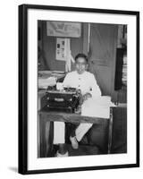 A Young Man Sitting at a Typewriter, Indonesia, 20th Century-null-Framed Photographic Print