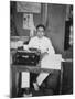 A Young Man Sitting at a Typewriter, Indonesia, 20th Century-null-Mounted Photographic Print
