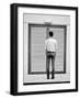 A Young Man Standing in the Street Looking at a Pair of Doors-India Hobson-Framed Photographic Print