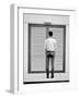 A Young Man Standing in the Street Looking at a Pair of Doors-India Hobson-Framed Photographic Print