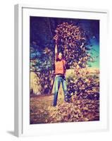 A Young Man Throwing Leaves in the Air-graphicphoto-Framed Photographic Print