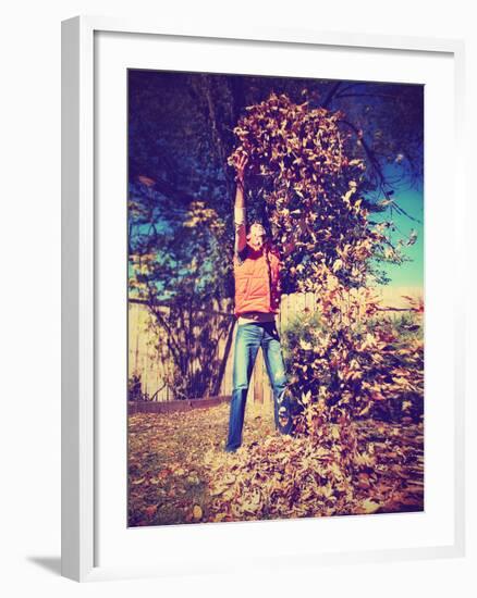 A Young Man Throwing Leaves in the Air-graphicphoto-Framed Photographic Print